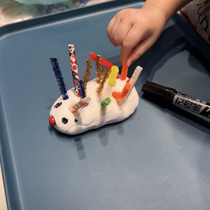 Clay hedgehog with pipe cleaner spikes