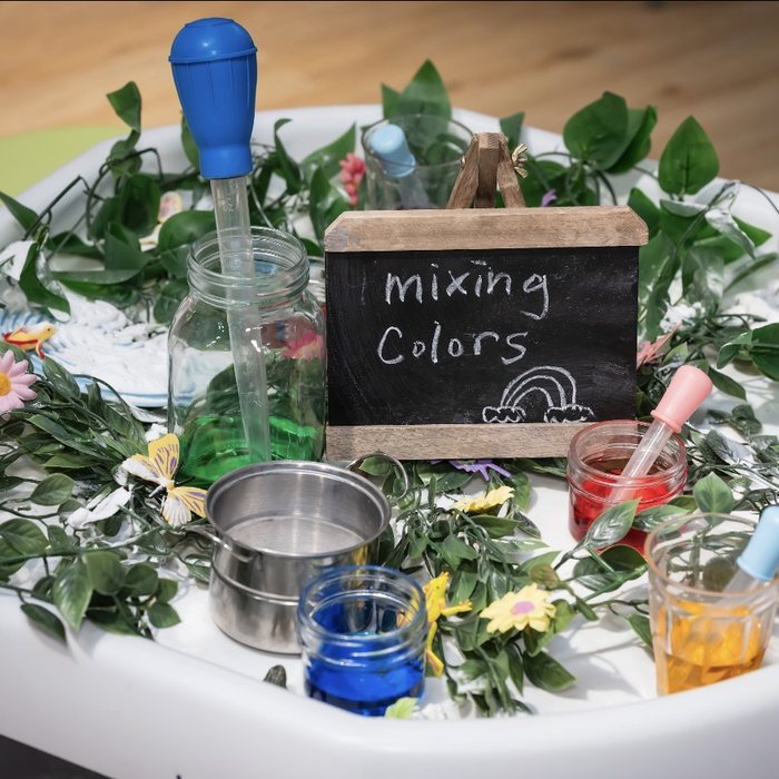 Colour mixing station with droppers and jars of coloured water