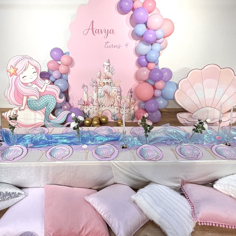 Mermaid party with shell backdrop, balloons and shell plates