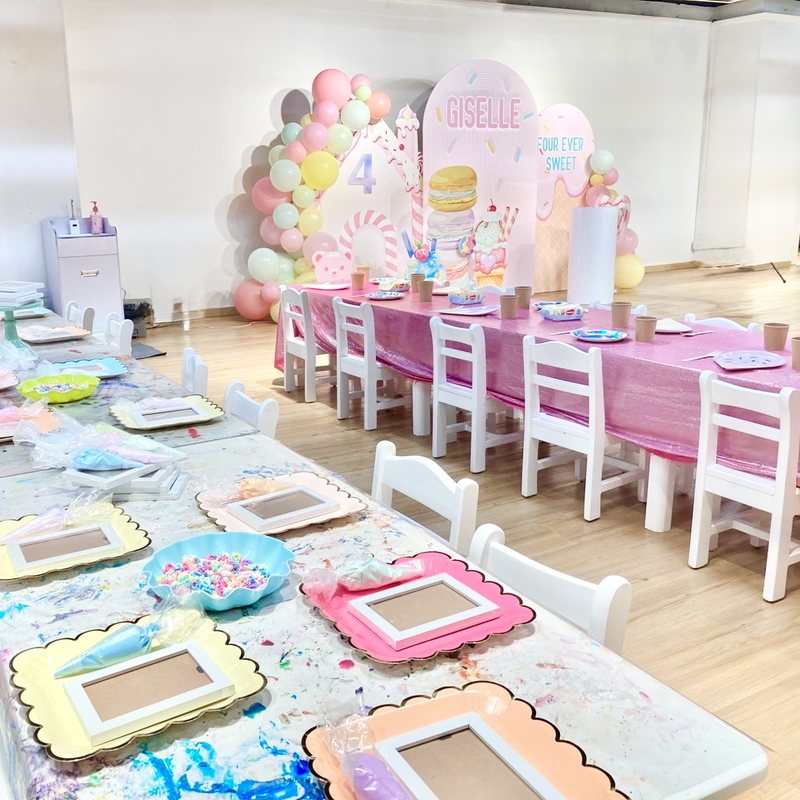 Sweet treats party with ice cream backdrop and craft table